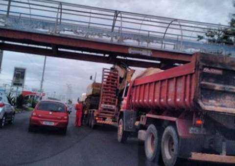Carreta bate e fica travada na passarela