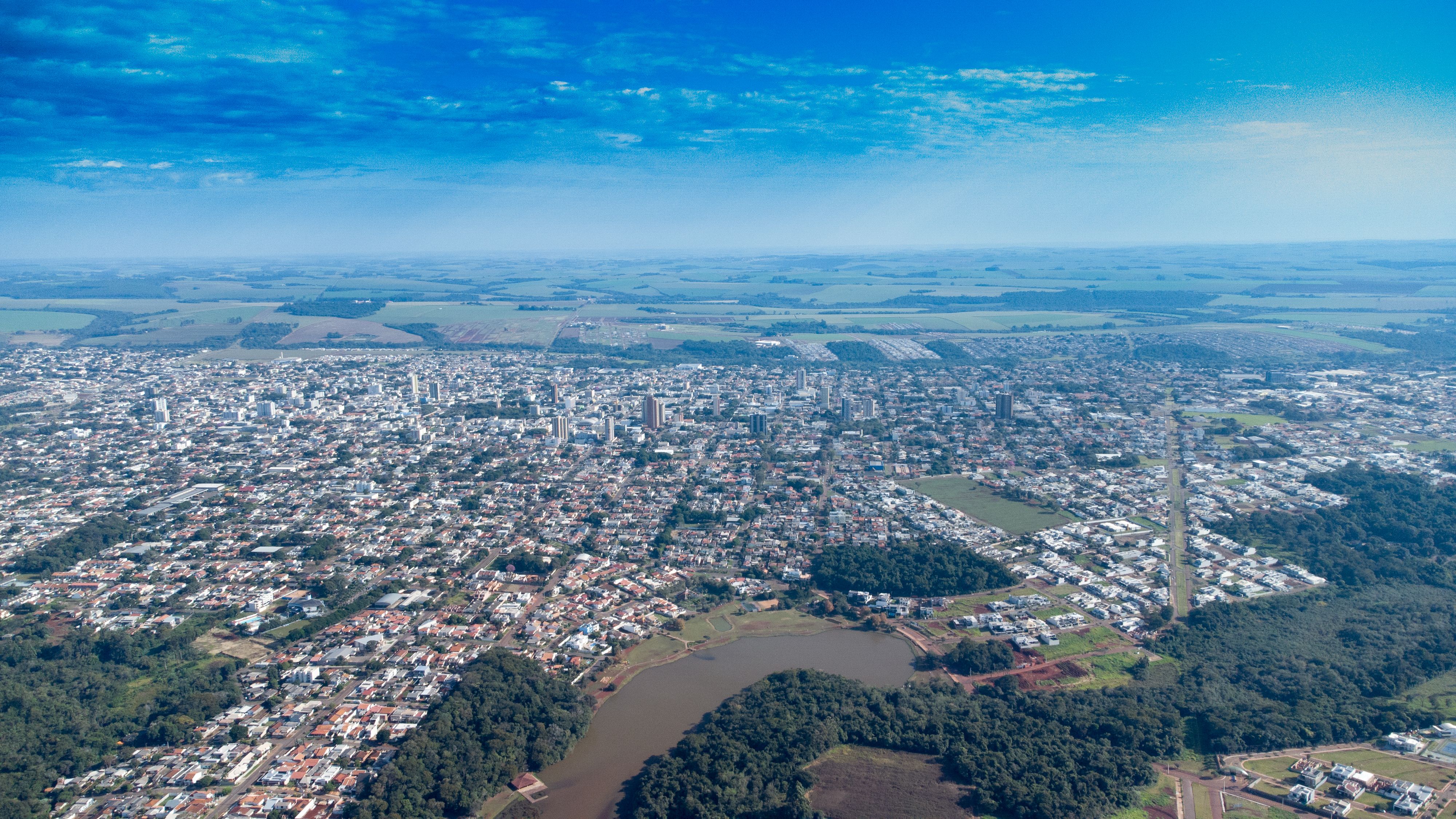 Stunning aerial view of Campo Mourão, Brazil showcasing the city's expansive landscape under a bright blue sky.